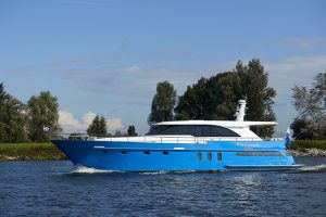 A blue and white motor yacht on the water